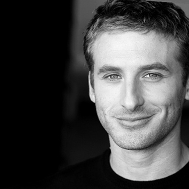 Black and white headshot of Fit To A Tee's founder and CEO, Justin Schurtz.