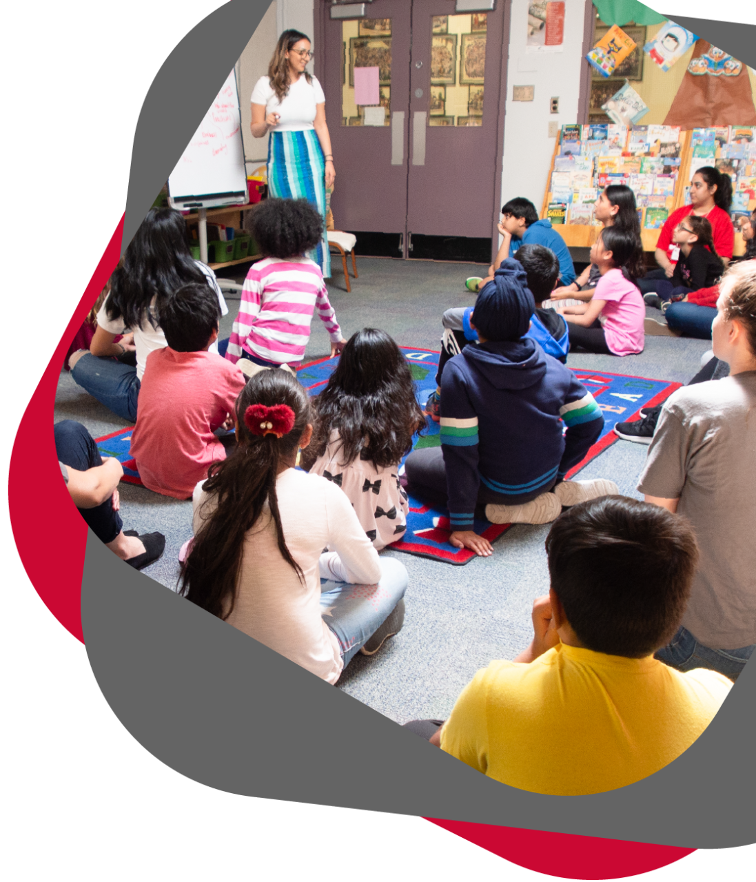 Volunteer giving a lesson to students in a classroom.