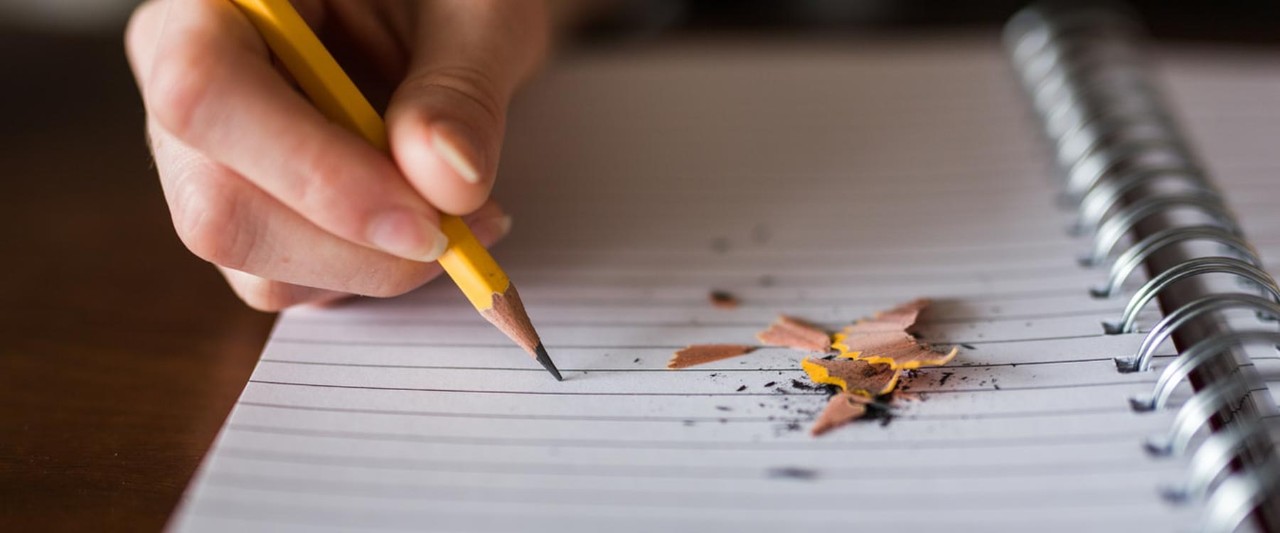 Pencil writing on a notebook.