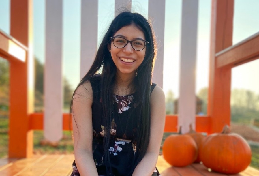 Vanshika Mahajan posing at a pumpkin field