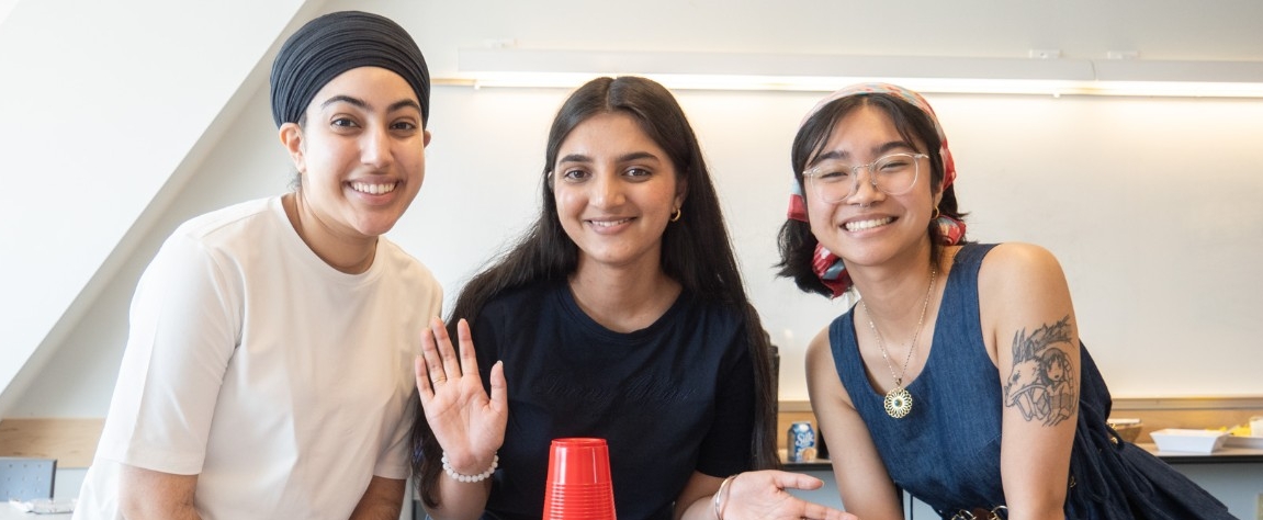 Volunteers smiling happily at the camera