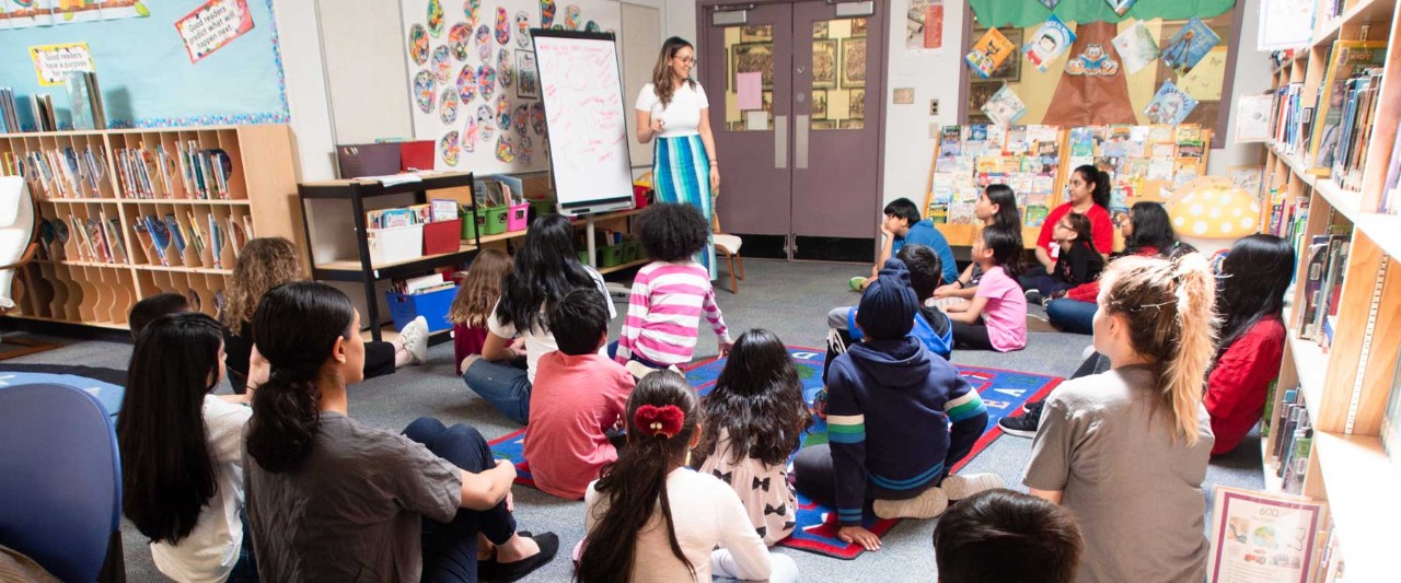 Volunteer teaching a classroom of student