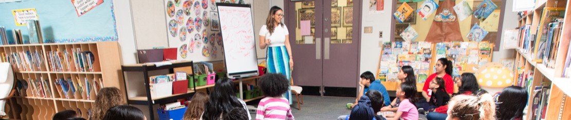 Volunteer teaching in a classroom setting with students