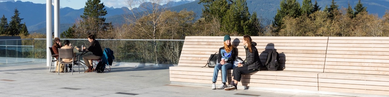 Students sitting outside and talking at SFU Burnaby