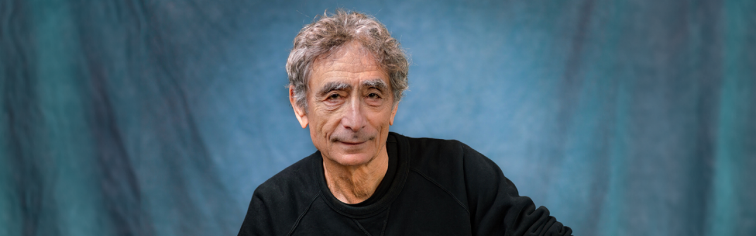 Image of the 2024 Sterling Prize winner Dr. Gabor Maté, looking at the camera with a blue background behind him.