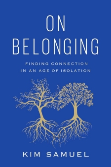 The book cover for On Belonging: Finding Connection in an Age of Isolation by Kim Samuel, with the text written in white lettering against a dark blue background. Two golden trees with interlocking roots are at the center.