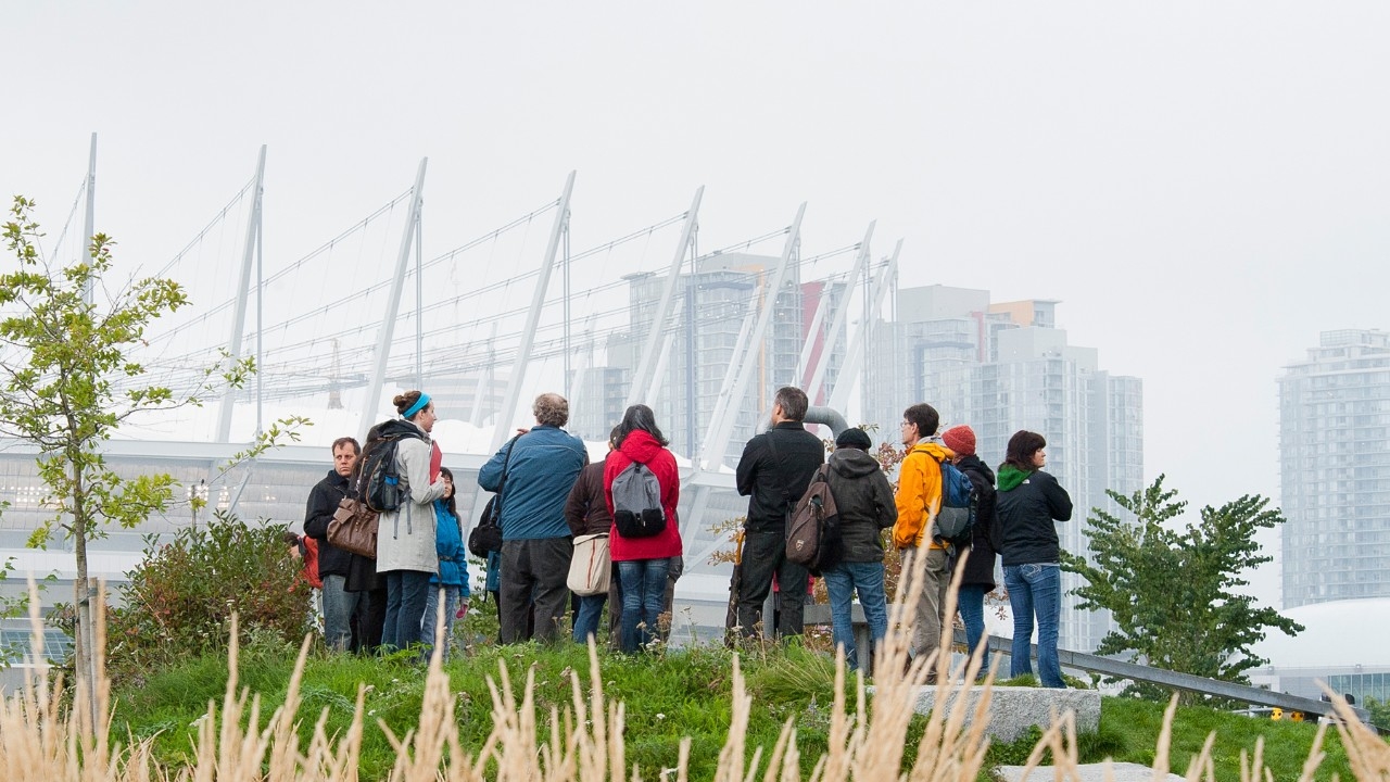 People facing the Vancouver cityscape; header: international applicants