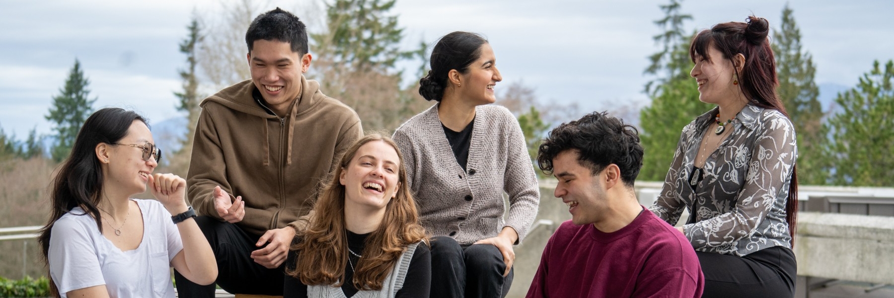 a group of students sitting and laughing together