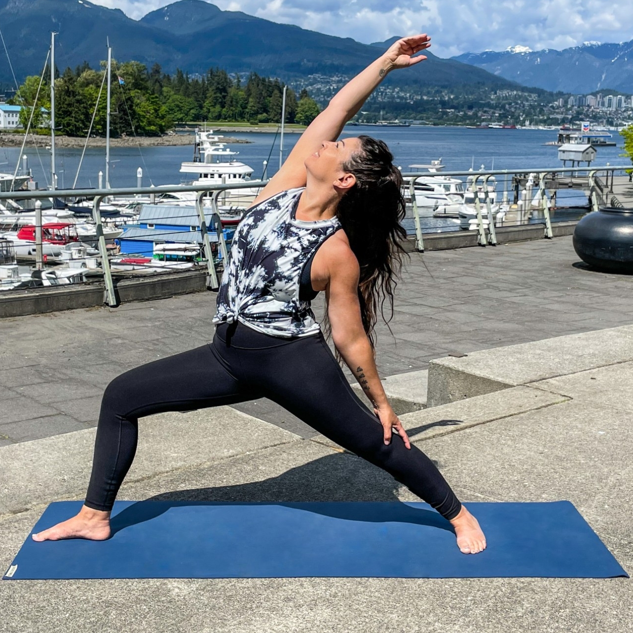 Wellness Class instructor, Pamela Ferman, practicing yoga outside along the Vancouver Seawall