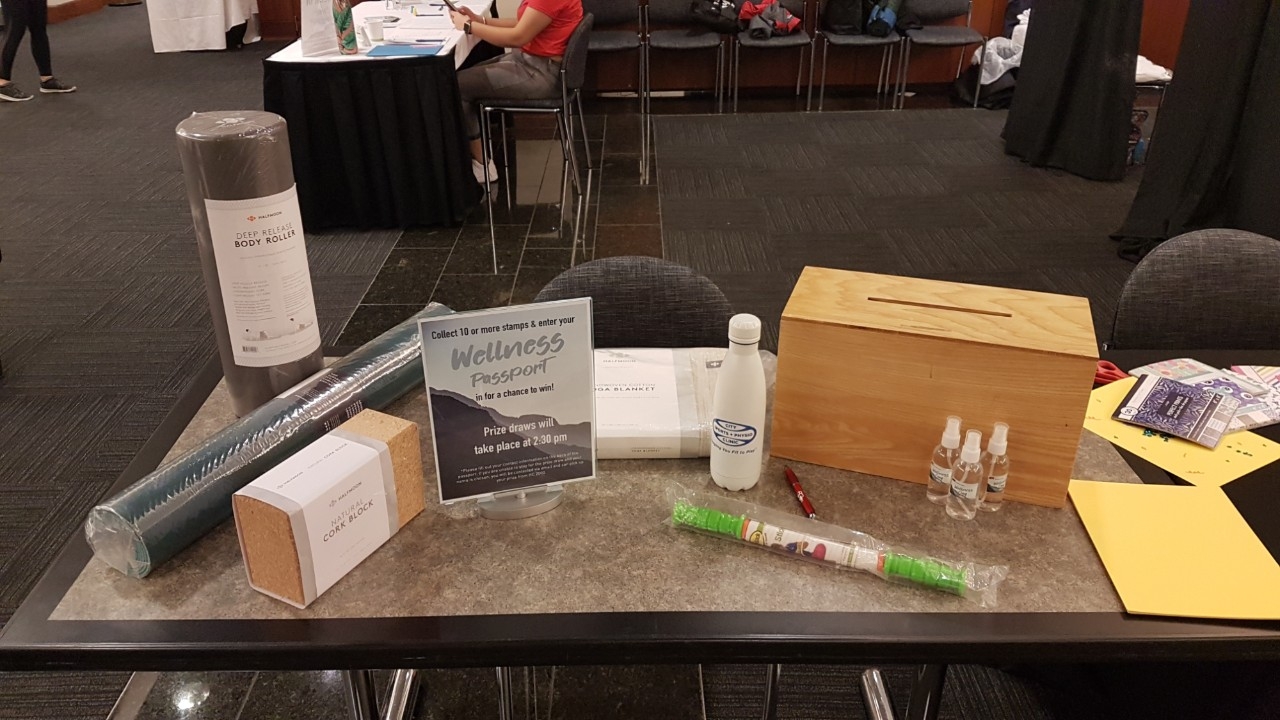 Various prize items and ballot box for prize draw entries set up on table as part of February 2020 Wellness Day