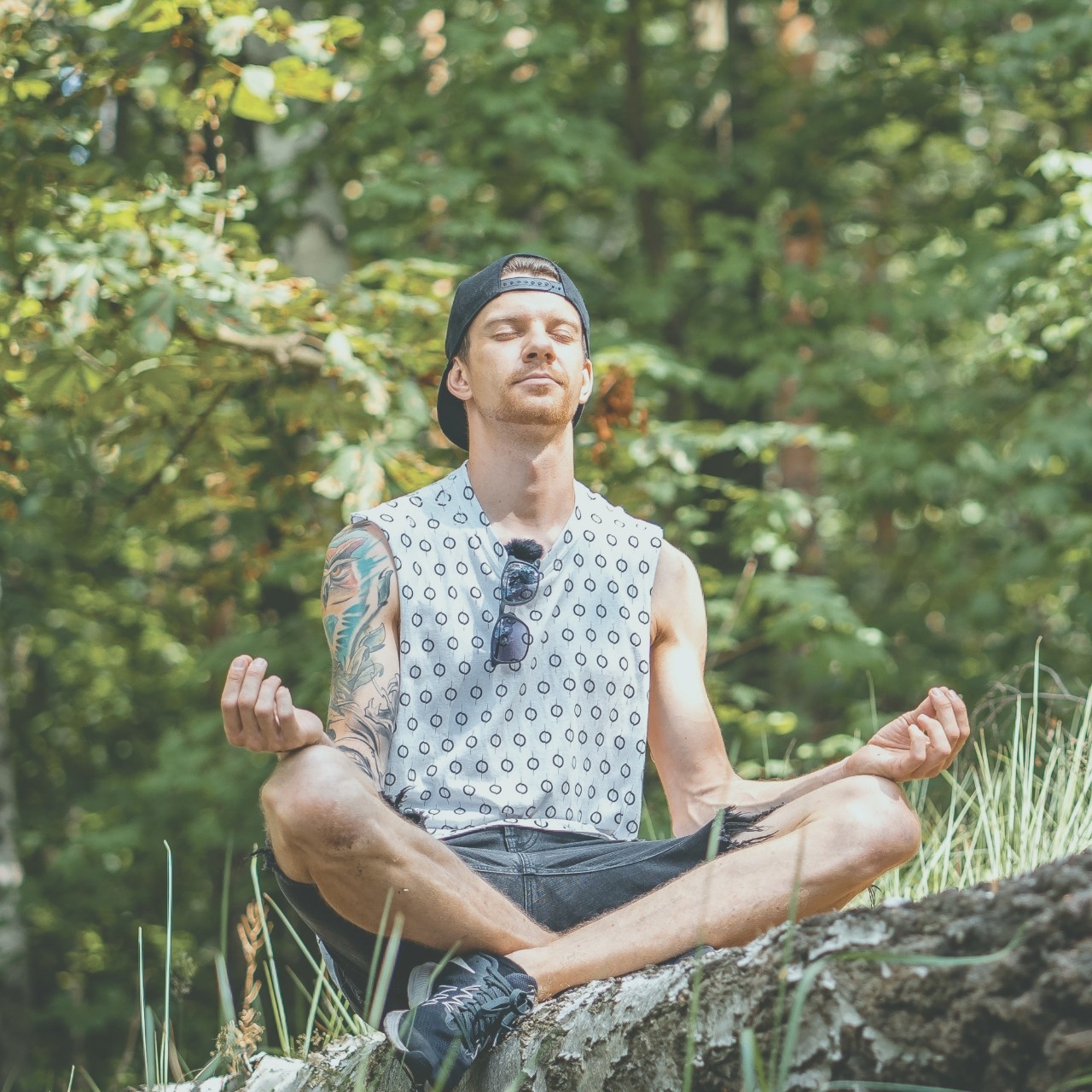 Person sitting outdoors in nature practicing meditation