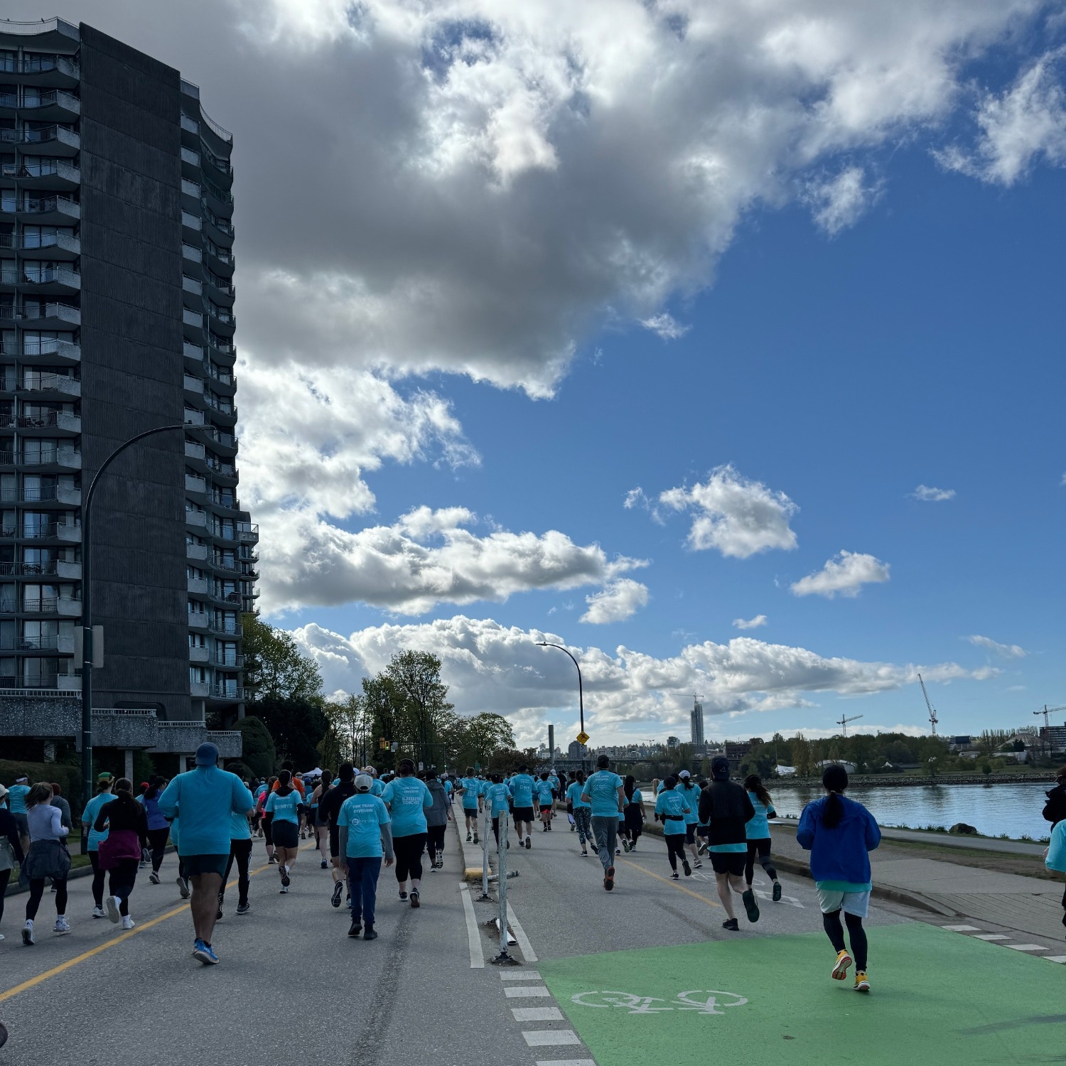 Participants running along a scenic West End waterfront