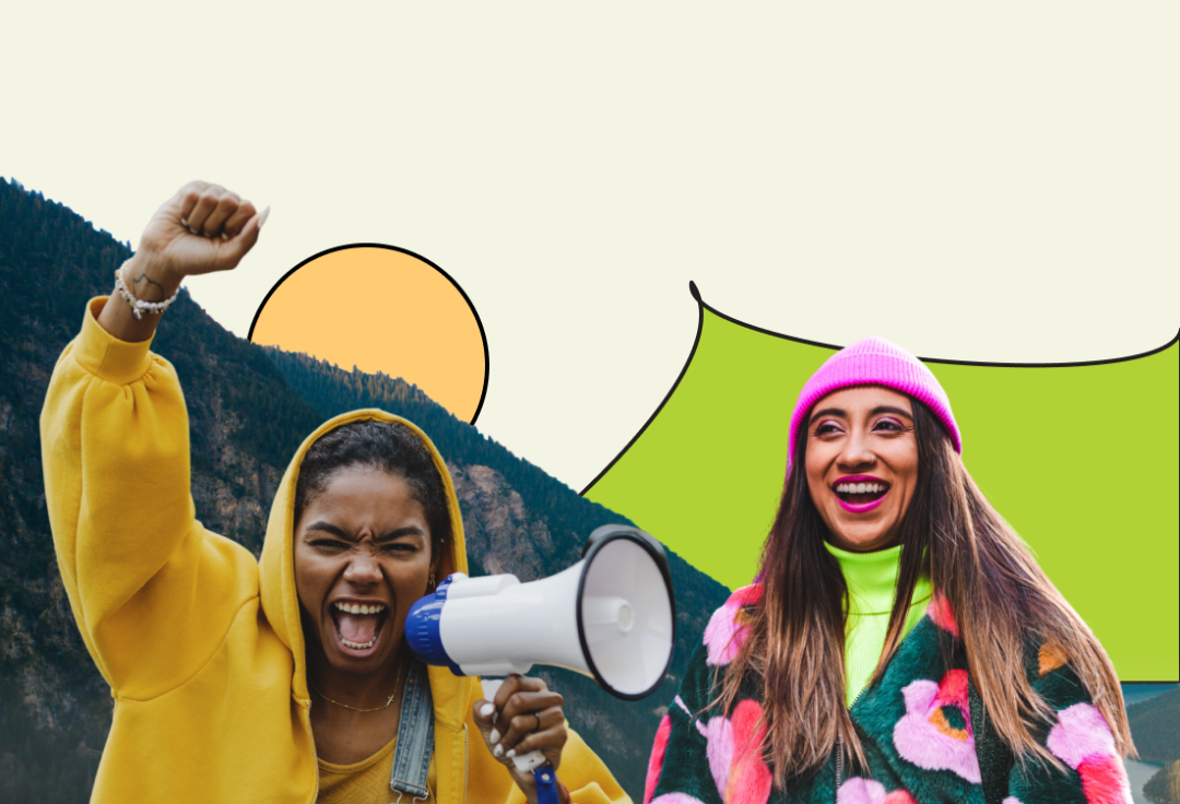 Two women cheering in front of a mountain, wkith one holding a megaphone