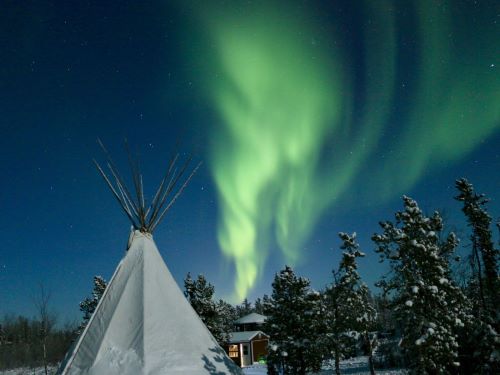 a white tent under aurora at Yellow Knife