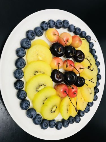 fruit platter with cherries, kiwi, and blueberries. 