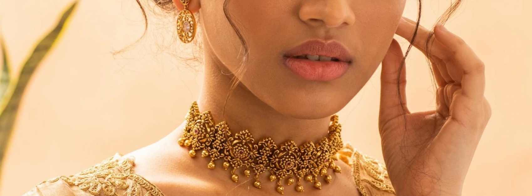 model wearing gold ornate choker