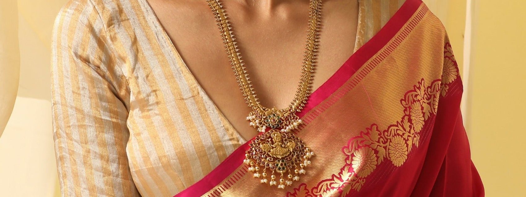 model wearing long ornate necklace