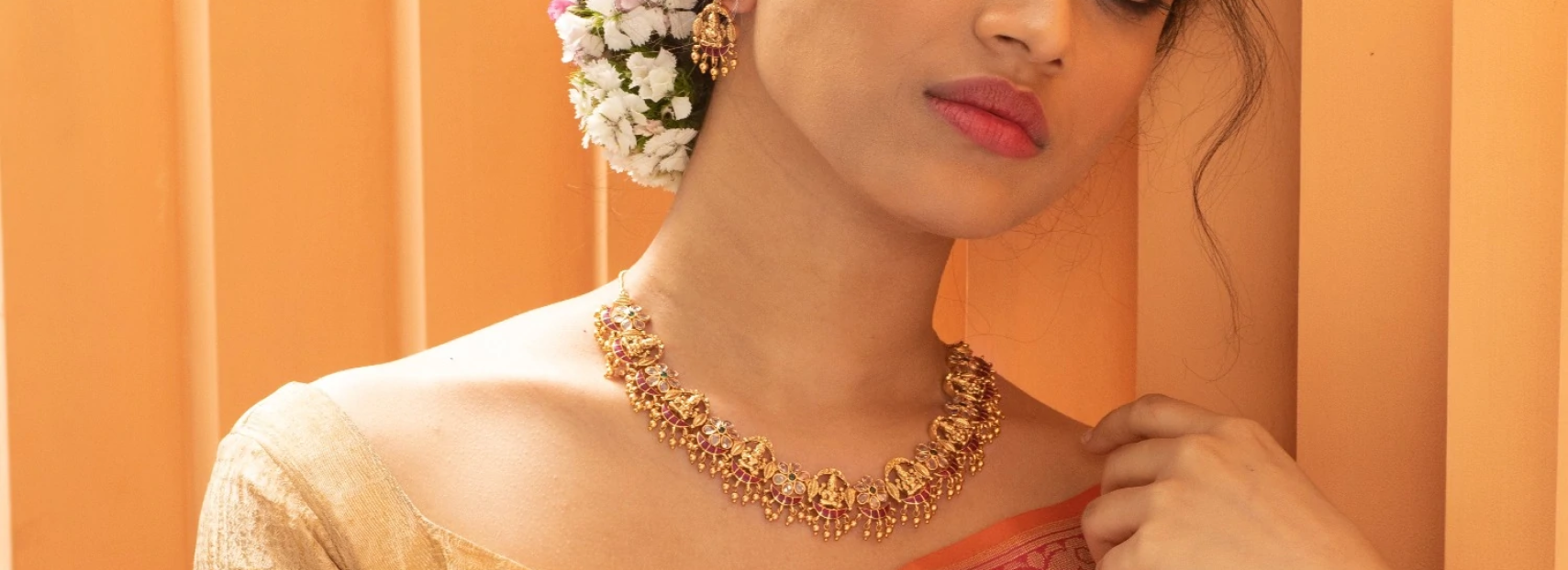 model wearing dangling bee earrings with diamond and ruby gems
