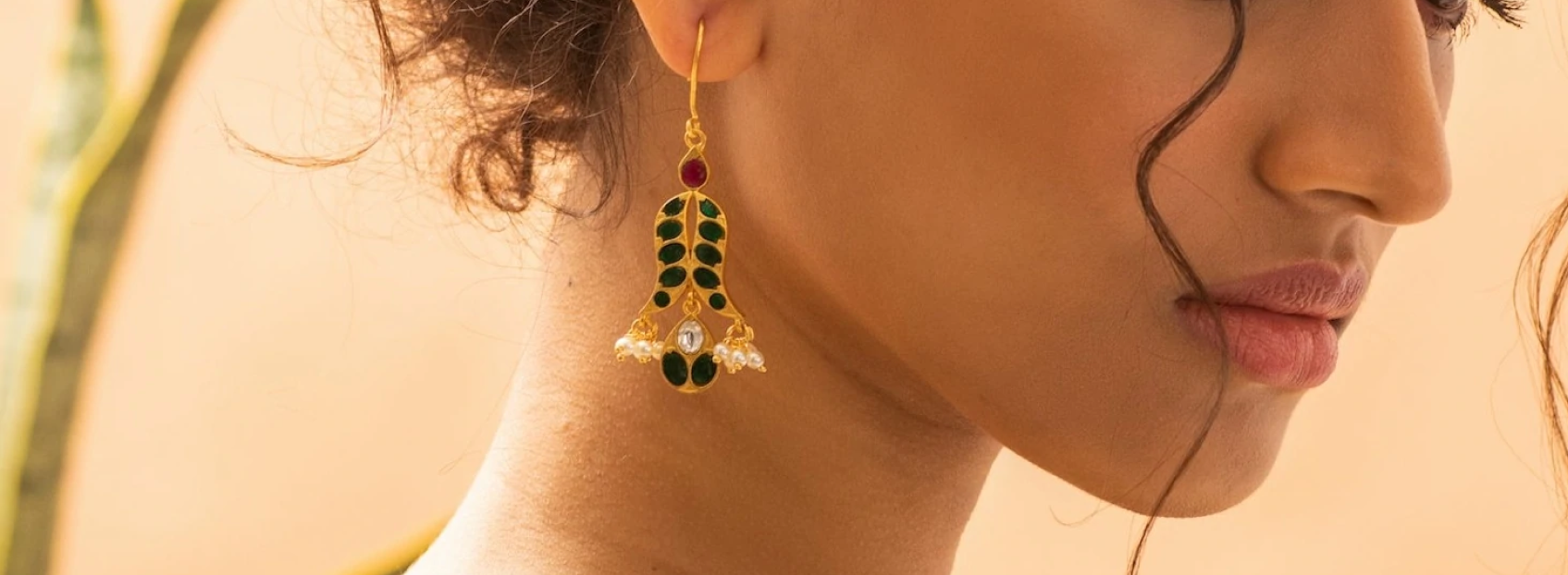 model wearing dangling bee earrings with diamond and ruby gems