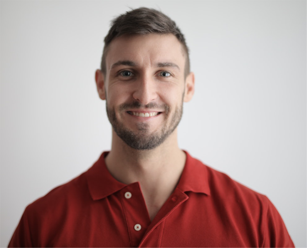 An image of a man in a red shirt and brown hair