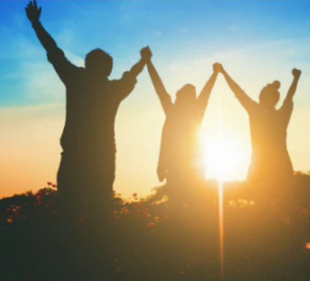 silhouette of people holding hands in the air