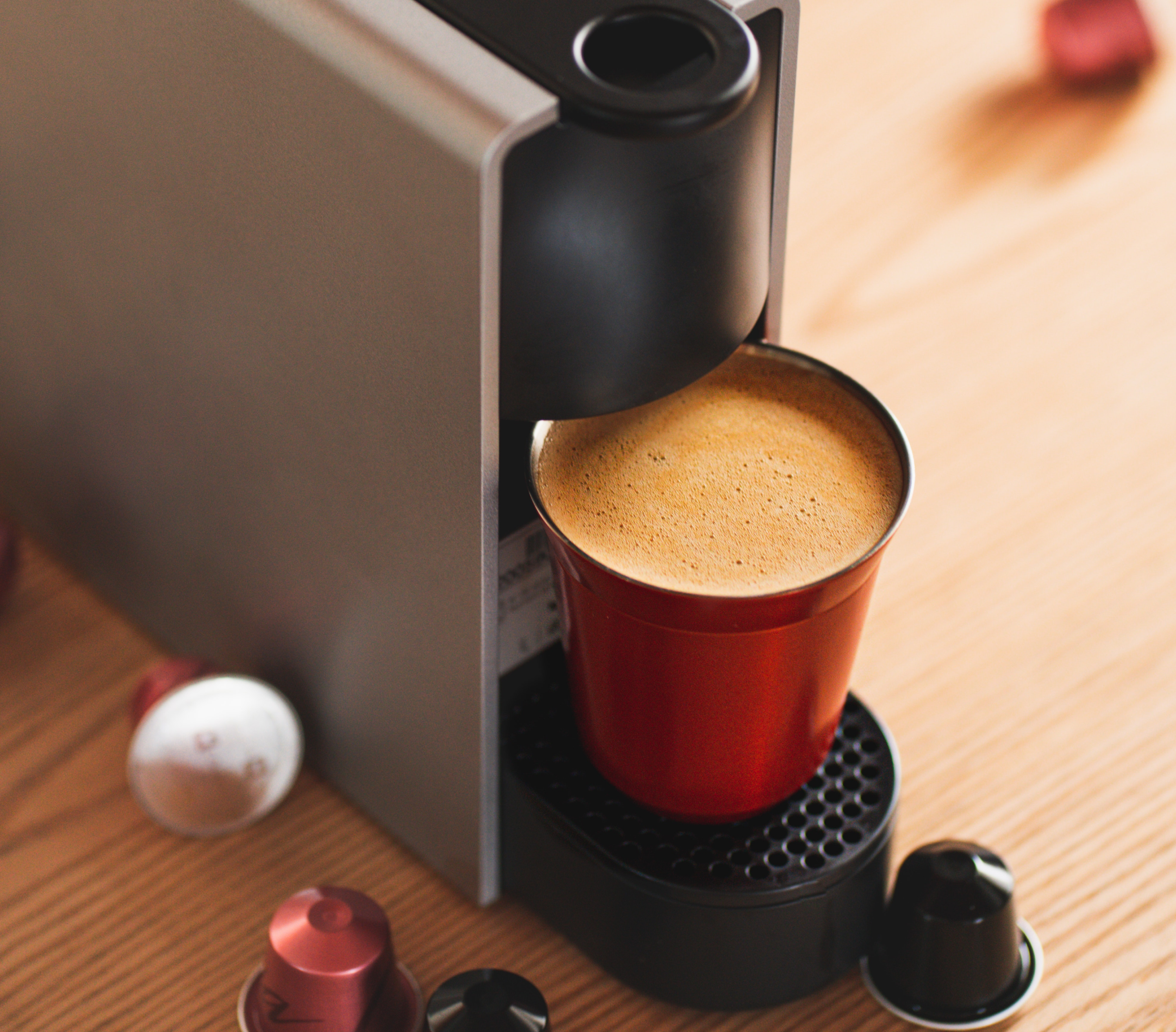 single serve coffee maker with a yellow mug and pods