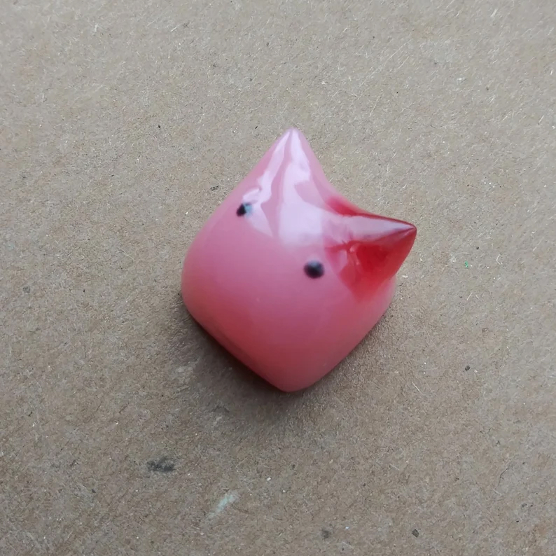 3D pink resin cat keycap with a red spot