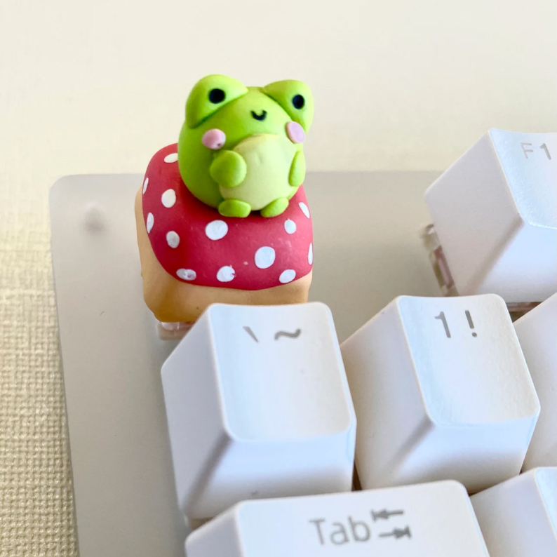 3D green frog sitting on a mushroom keycap