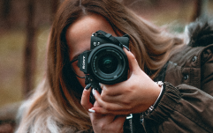 Kiara Parker holding a DSLR camera.