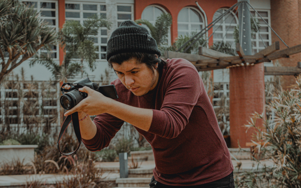 Samuel Rios holding a DSLR camera.