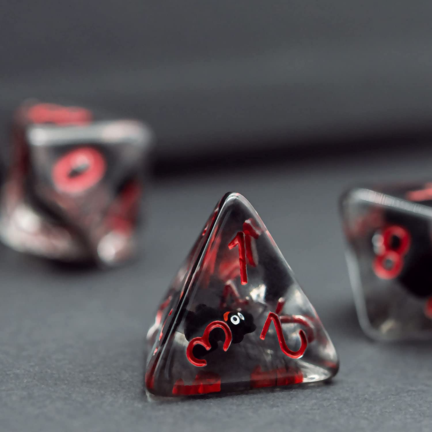 A D12 translucent bat resin dice, showing number 1 2 3