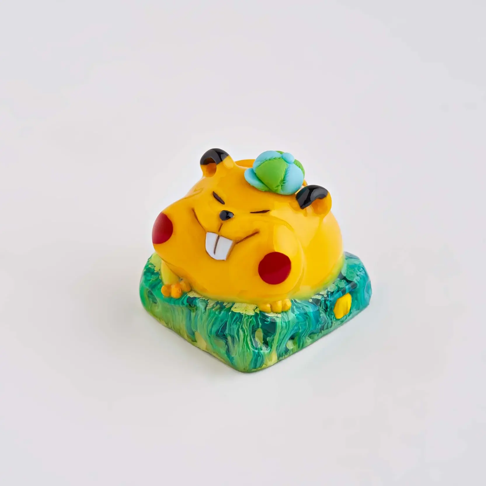 artisan keycap of yellow mouse sitting on green cheese