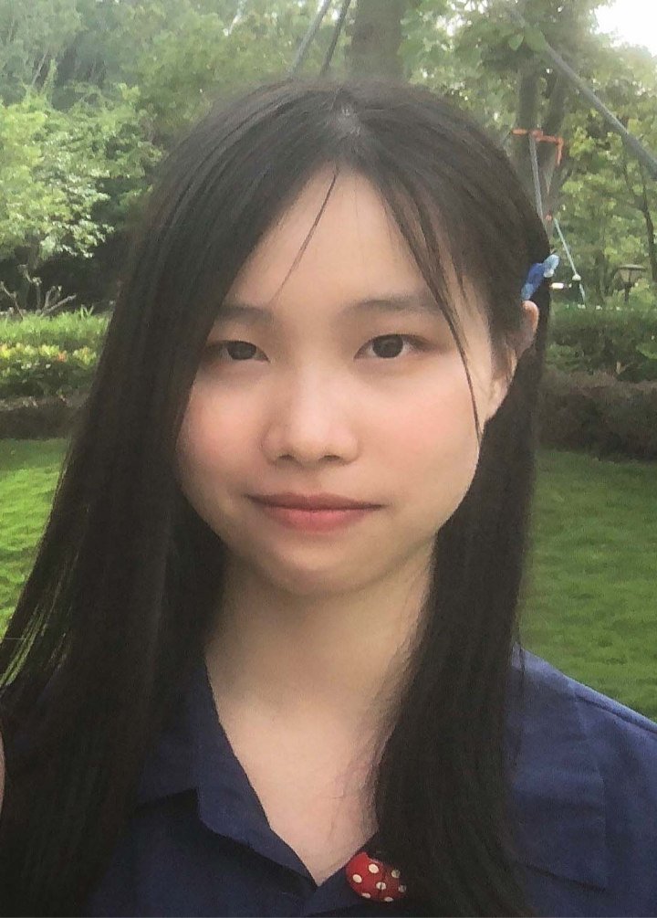 headshot of a smiley girl wearing blue blouse