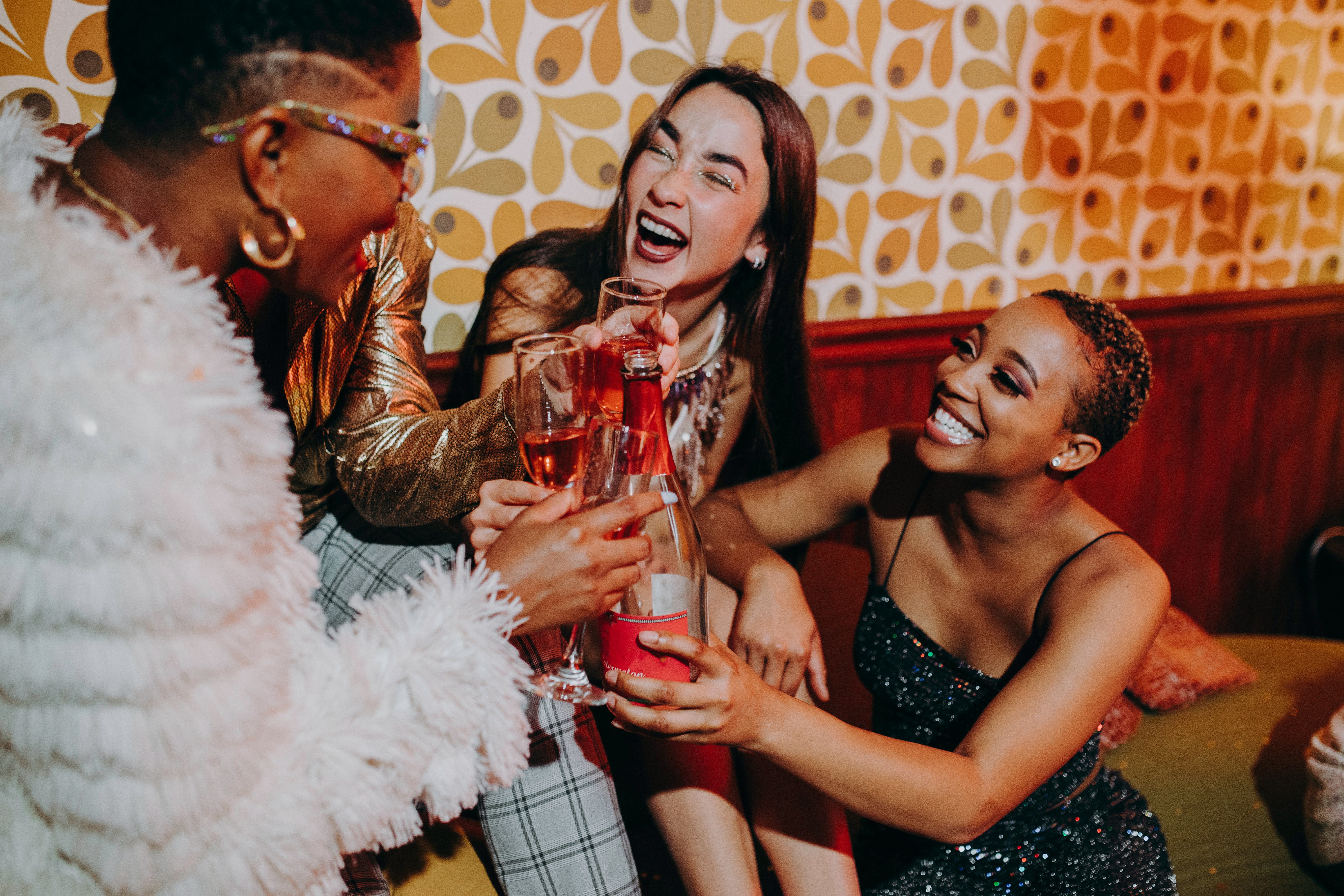 Friends at a party cheersing with their drinks