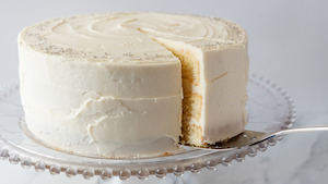 a vanilla cake with white frosting and silver sprinkles