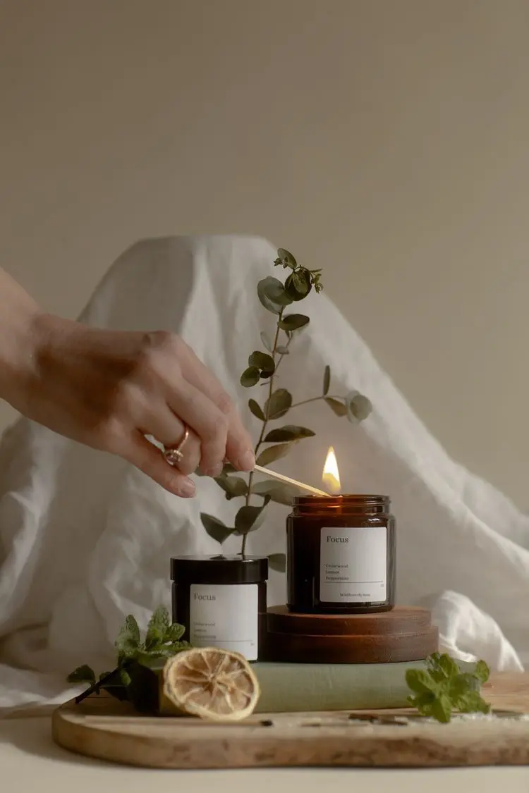 Picture of a hand lighting up a jar of scented candle