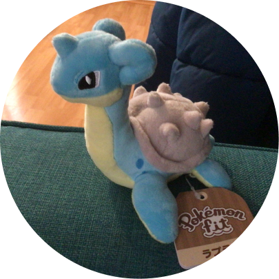 Review image of Sitting Cuties Lapras plush sitting on a couch arm