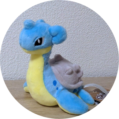 Review image of Sitting Cuties Lapras plush sitting on a wood table against a white wall