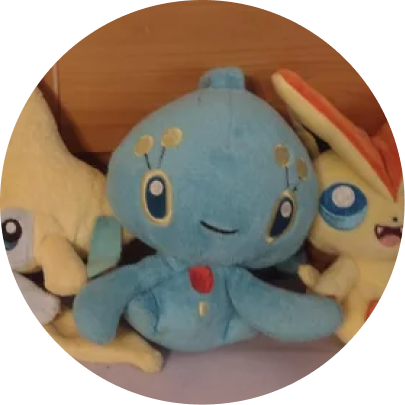 Review image of Sitting Cuties Manaphy plush sitting amongst 2 other Pokemon plushies.