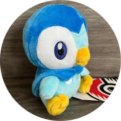 Review image of Sitting Cuties Piplup plush sitting on a wood background