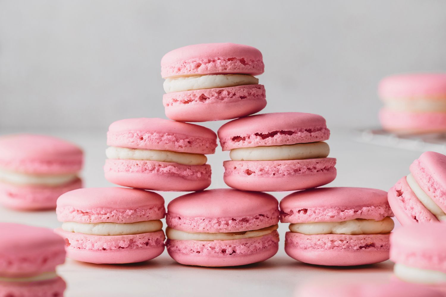 A picture of a stack of pink macarons