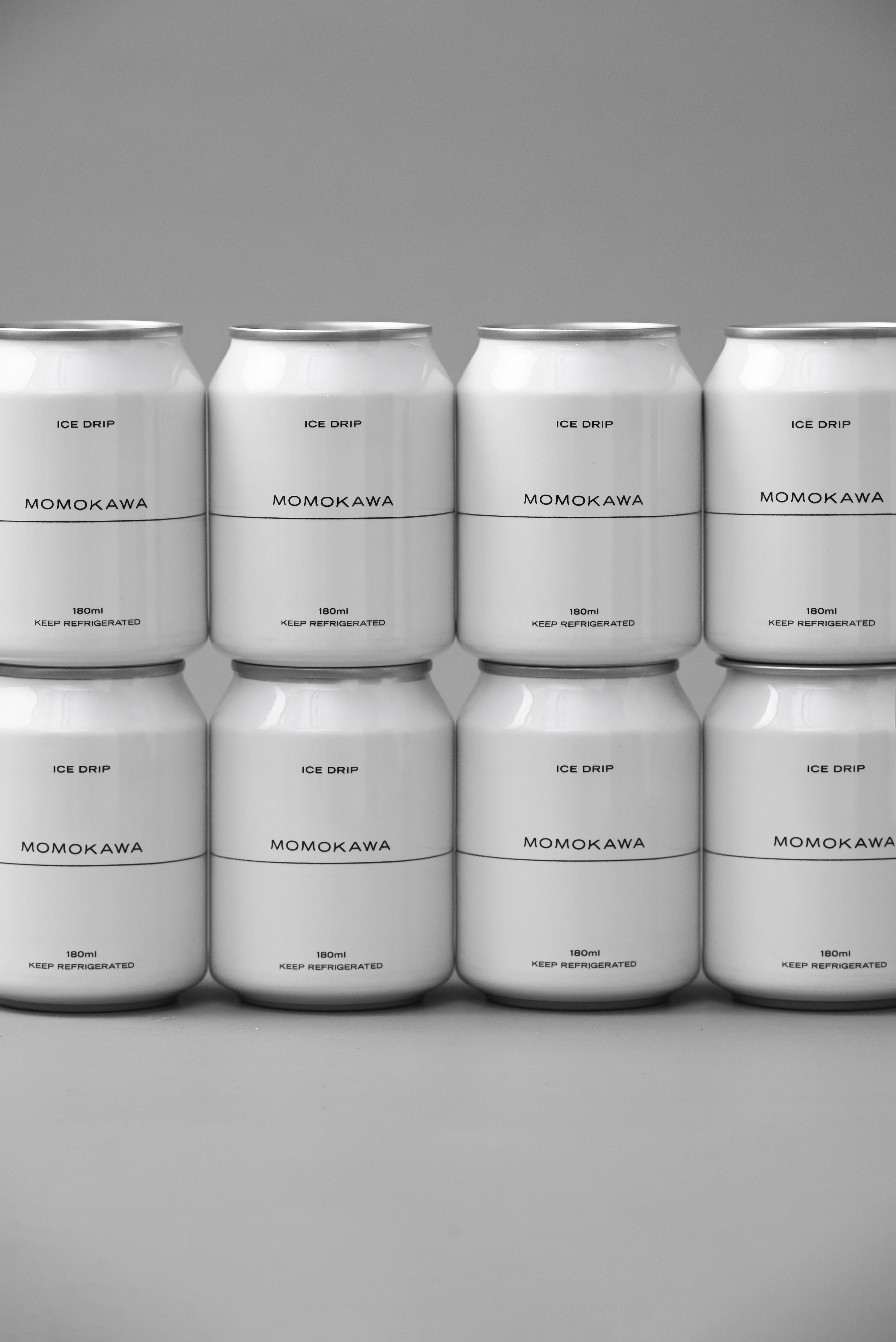 An image of MOMOKAWA's cofffee cans that links to MOMOKAWA Drink Menu