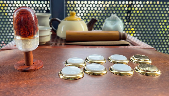 Wood arcade stick with gold/white buttons and cast resin top.