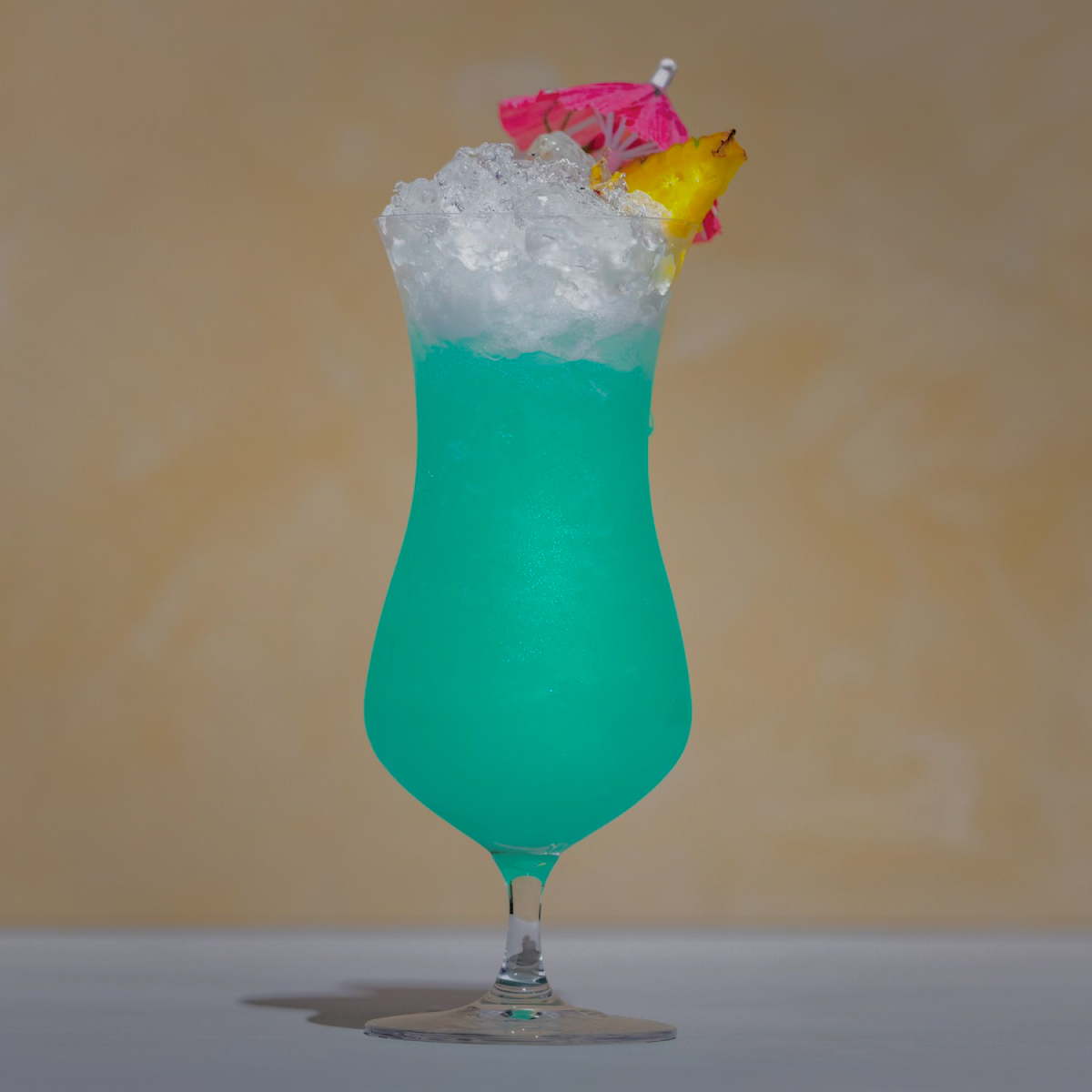 Blue Hawaii: a blue drink with ice, has a Pineapple slice and umbrella