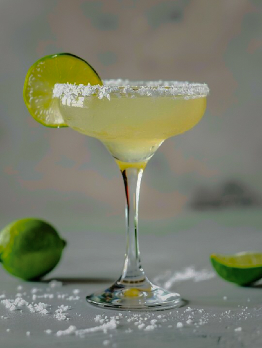 Margarita: a white drink with a lime garnish