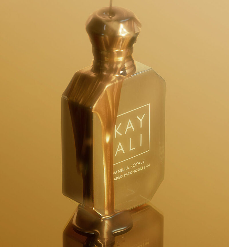 Thick and shimmery golden liquid dripping onto perfume bottle