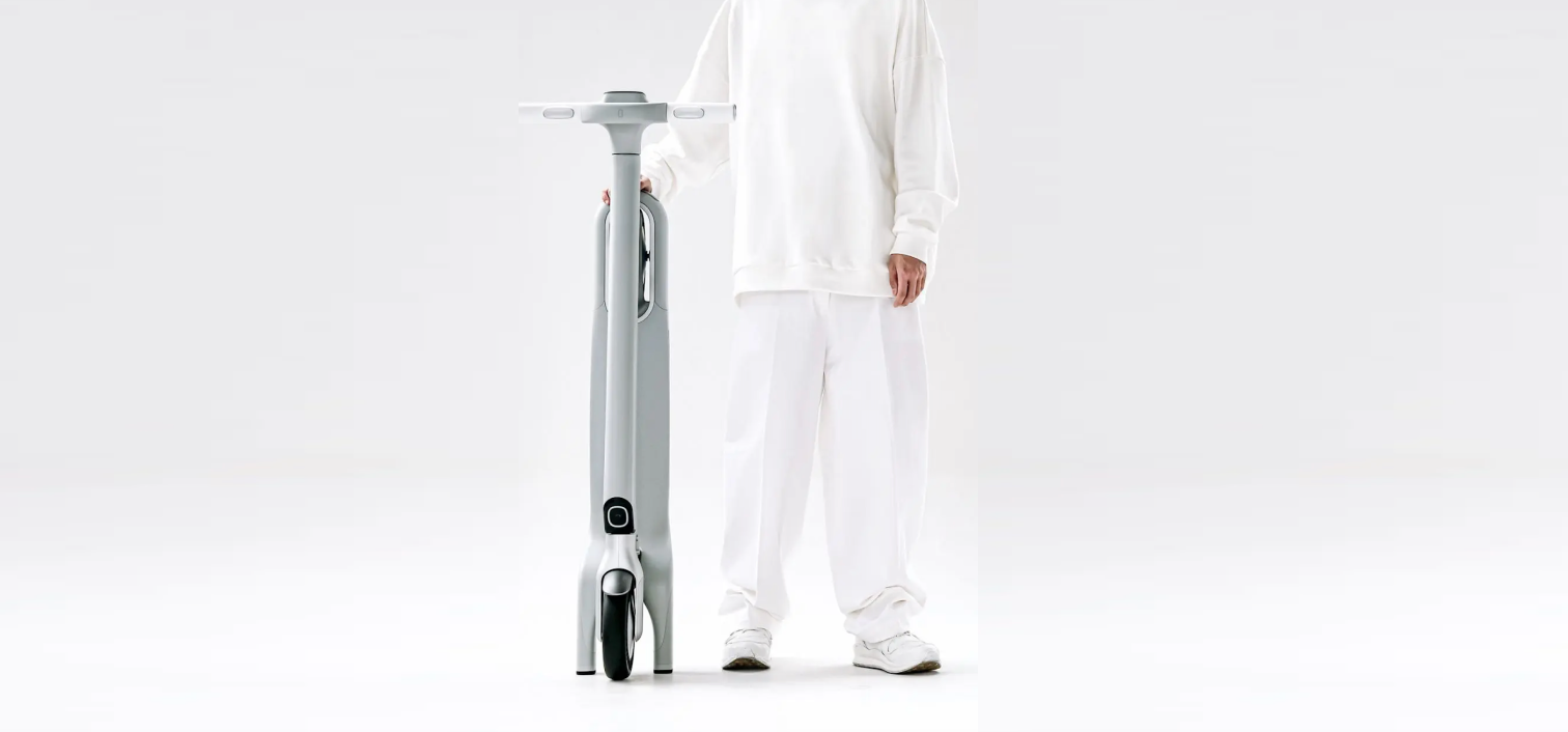 a person holding a electric scooter