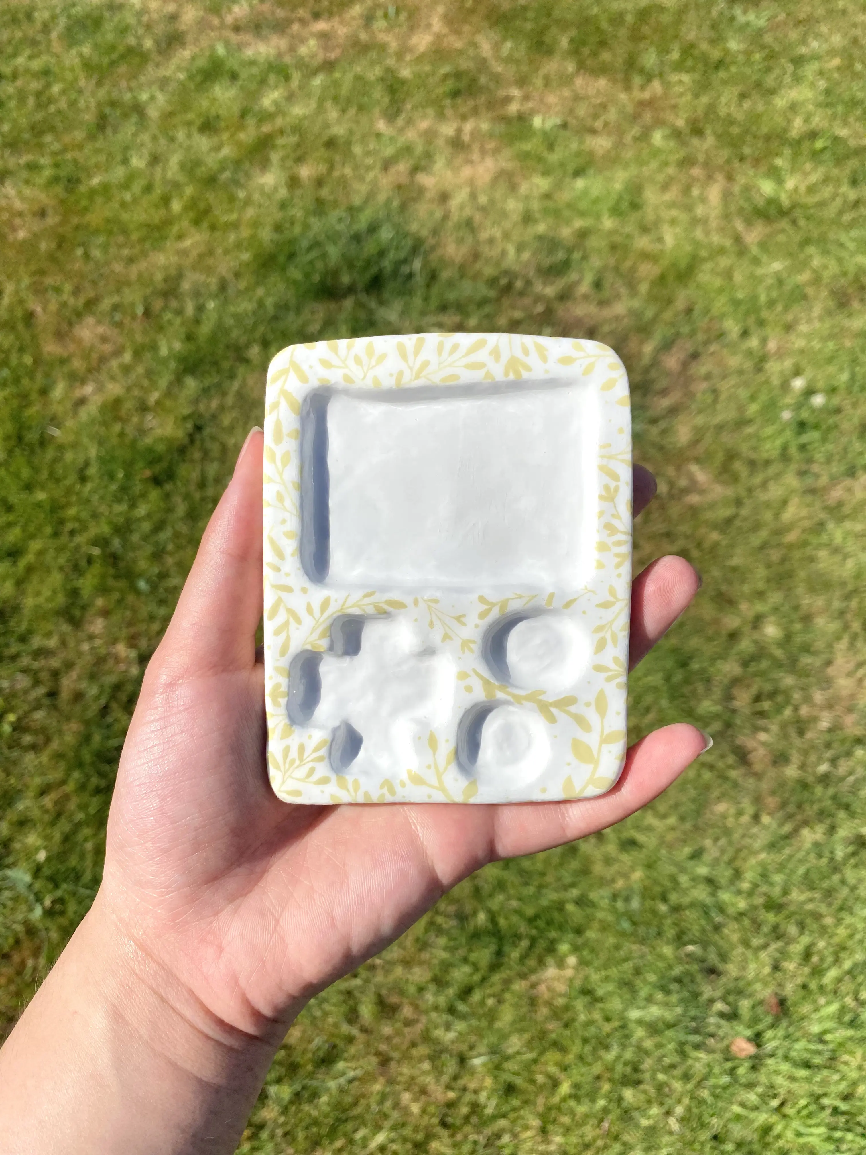 A photo of a mini Game Boy trinket dish with a vain pattern