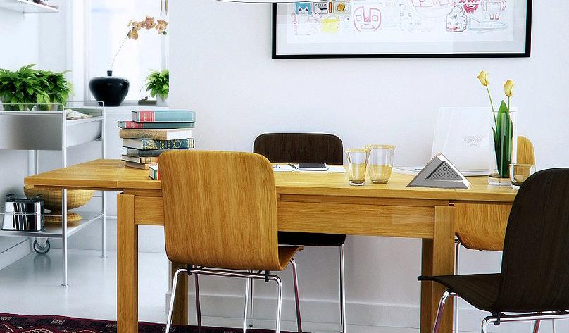 A well lit living room with wooden furniture and a Bluetooth speaker sitting on top of the table.