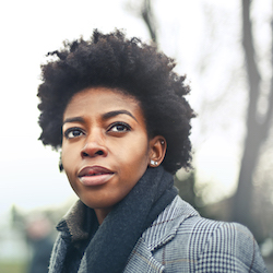 Image of a black woman in a grey coat